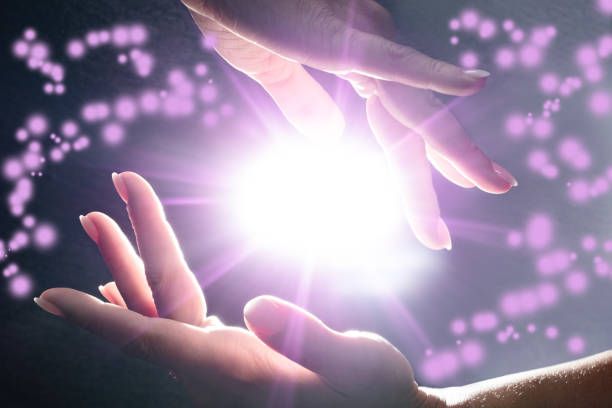 Reiki purplrewith light in hands.jpg_1677615476